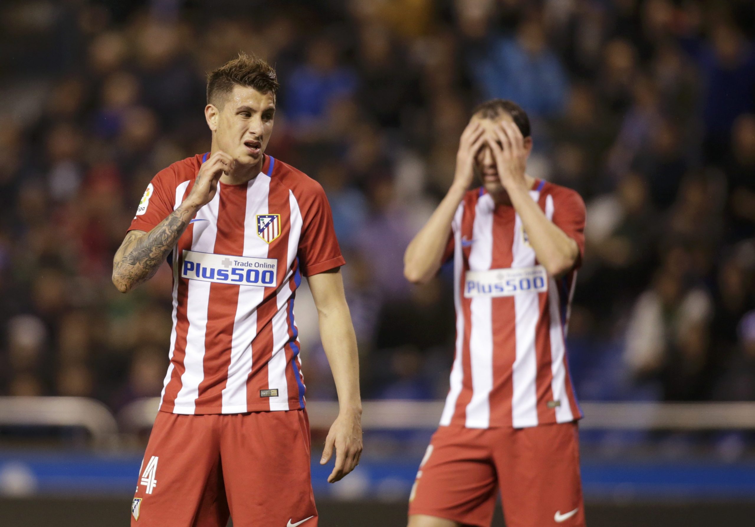 Atletico Madrid's Jose Maria Gimenez and Diego Godin react.
